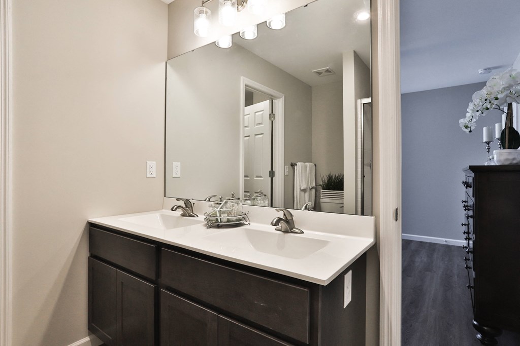 a bathroom with a large mirror and a sink