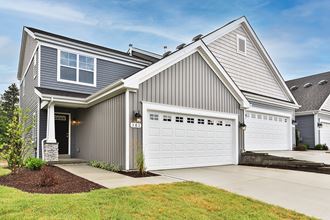 a house with a white garage door and a driveway
