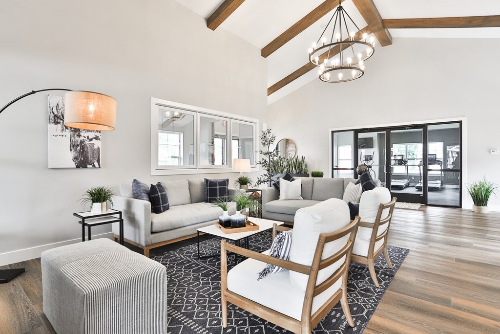 a living room with couches and chairs and a table