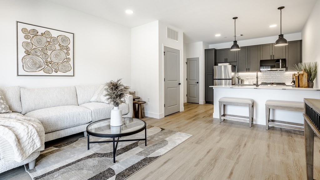 A modern living room with a white sofa and a coffee table.