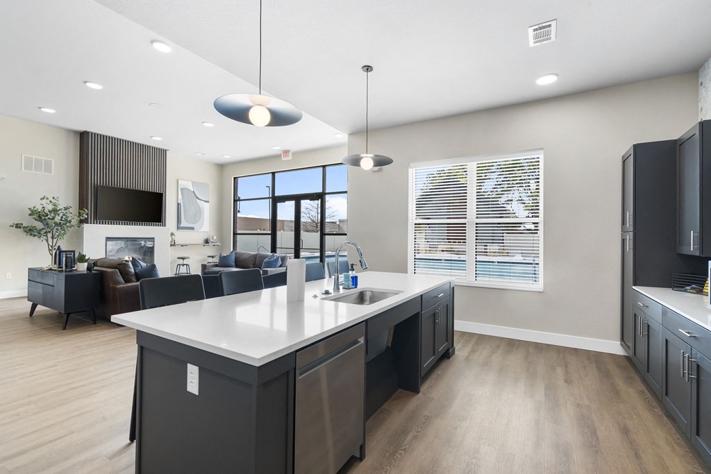 an open kitchen and living room with a large white counter top at The Junction at Rogers, Rogers, Arkansas