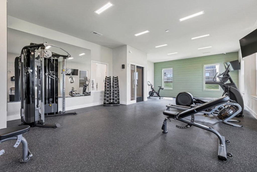 the gym is equipped with cardio equipment and weights at The Prairie Luxury Apartments, Dardenne Prairie