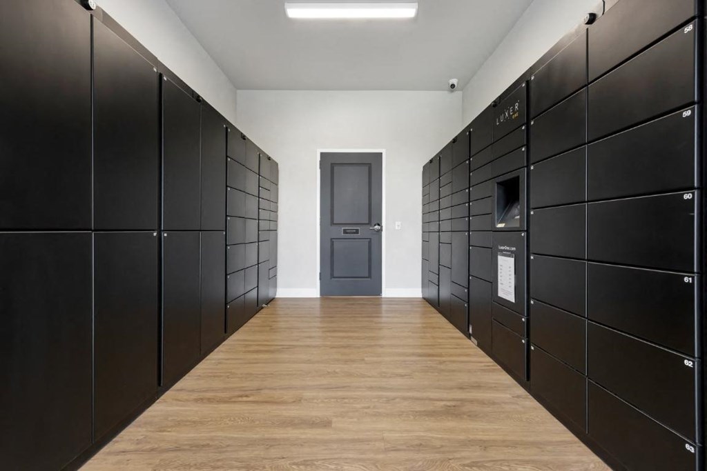 a room filled with black lockers and a door at The Prairie Luxury Apartments, Dardenne Prairie Missouri