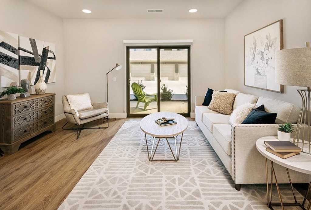 a living room with a couch and a table at The Prairie Luxury Apartments, Missouri
