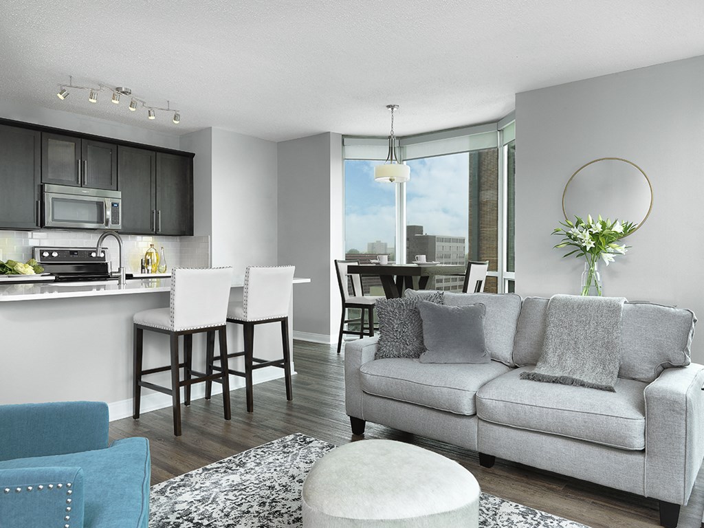 Apartment living room, kitchen and floor-to-ceiling window  at Clayton On The Park, Clayton, Missouri