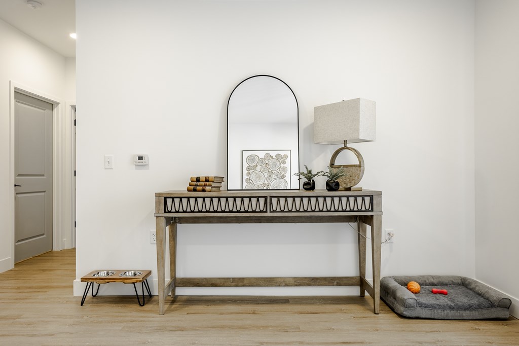 A table with a mirror and some decorative items on it.