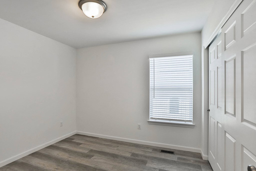 an empty room with a window and a white door at The Prairie Villas, Dardenne Prairie, 63368