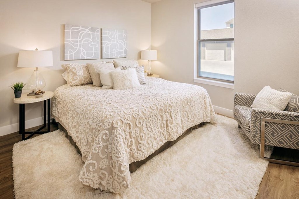 a bedroom with a bed and a window at The Prairie Luxury Apartments, Dardenne Prairie, 63368