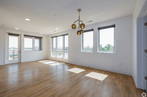 an empty living room with hardwood floors and a chandelier  at 2200 LaSalle, St Louis, Missouri