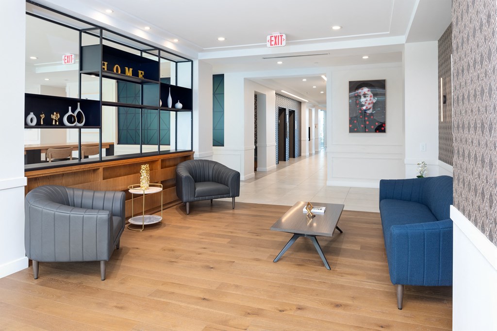 clubroom conversational seating area with sofa, two chairs and coffee table at 2200 LaSalle Apartments, St Louis, 63104