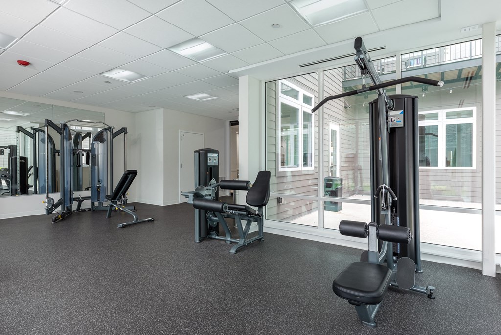 a gym with exercise equipment and a large window at 2200 LaSalle Apartments, St Louis, MO, 63104