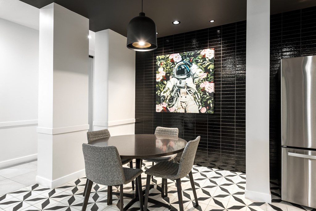 a dining room with a table and a painting on the wall at 2200 LaSalle Apartments, Missouri
