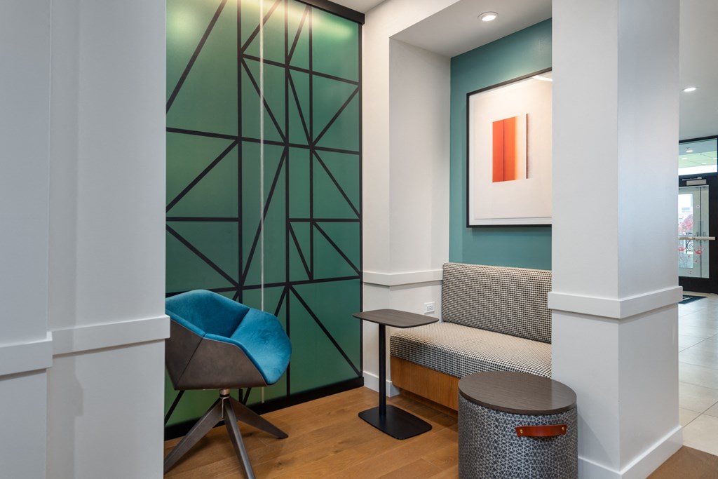 a living room with a couch and a chair and a green wall at 2200 LaSalle Apartments, St Louis, Missouri