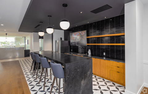 a kitchen with a long counter and chairs  at 2200 LaSalle, St Louis, MO, 63104