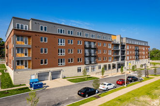 a large apartment building with a parking lot in front of it