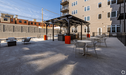 a patio with tables and chairs in front of a building  at 2200 LaSalle, St Louis, MO