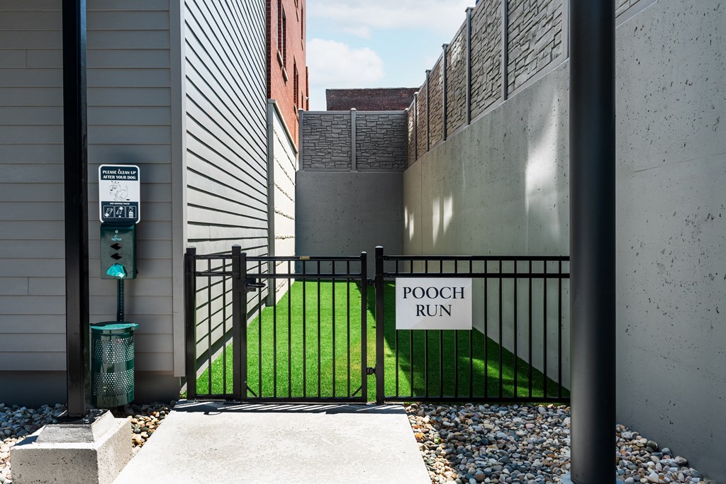a pool run sign on a gate in front of a grass yard at 2200 LaSalle Apartments, St Louis