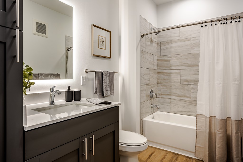 A bathroom with a white sink and a white bathtub at Prairie Encore, Dardenne Prairie, MO 63368