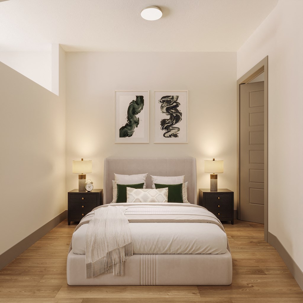 a bedroom with a bed and two paintings on the wall at Bemiston Place Apartments, Clayton, 63105