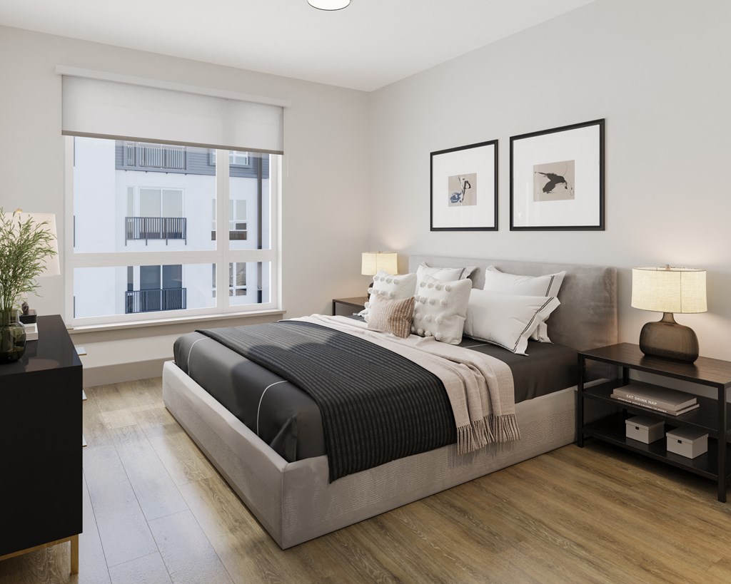 a bedroom with a bed and two windows at Bemiston Place Apartments, Clayton Missouri
