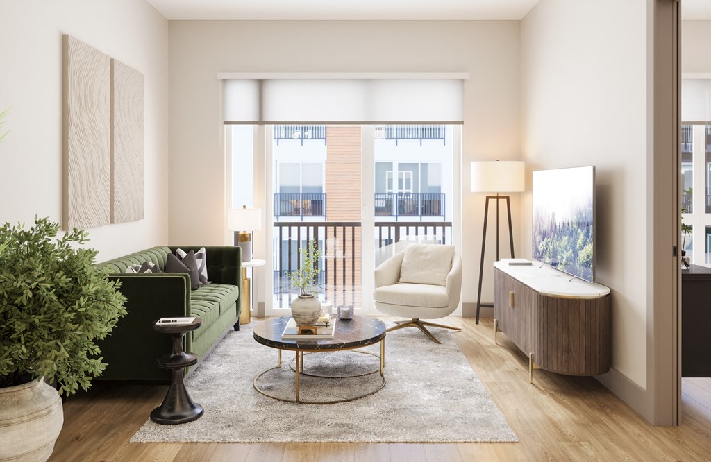 a living room with a green couch and a table at Bemiston Place Apartments, Missouri