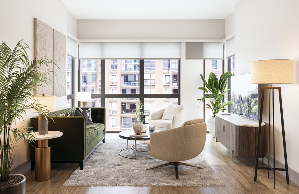a living room with a green couch and a large window at Bemiston Place Apartments, Clayton