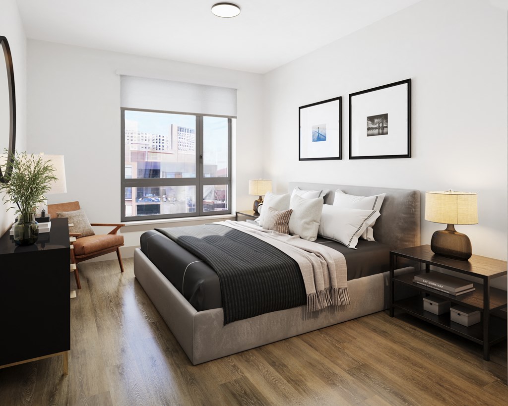 a bedroom with a large bed and a large window at Bemiston Place Apartments, Clayton Missouri