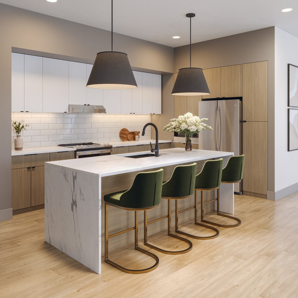 a kitchen with a marble counter top and four green chairs at Bemiston Place Apartments, Clayton, MO 63105