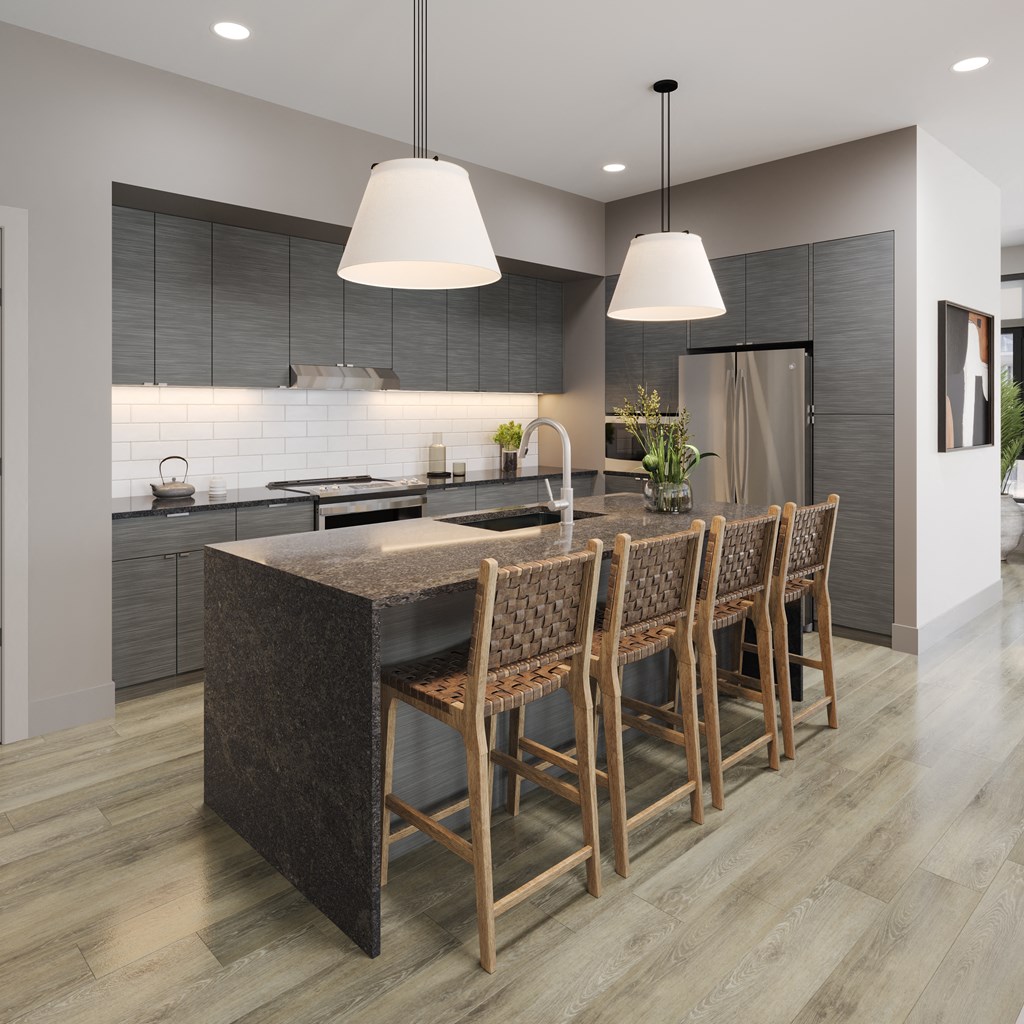 a kitchen with a large island and chairs in a house at Bemiston Place Apartments, Missouri, 63105