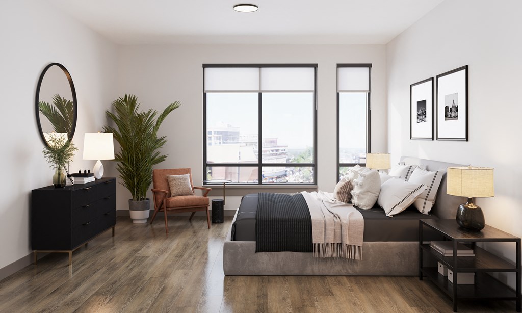 a bedroom with a large bed and a large window at Bemiston Place Apartments, Missouri, 63105
