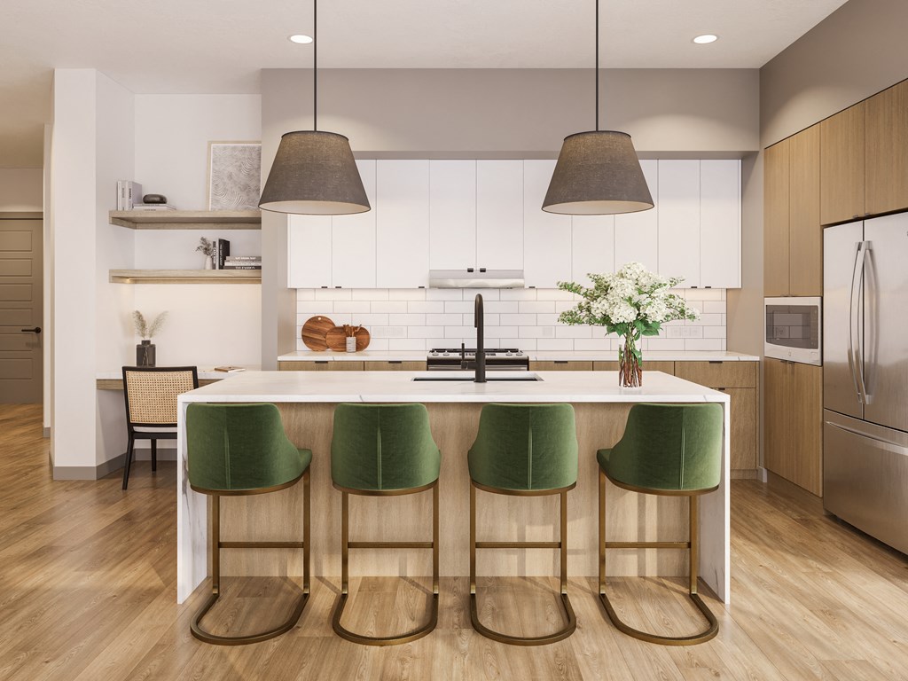 a kitchen with white cabinets and a white island with green chairs at Bemiston Place Apartments, Missouri 