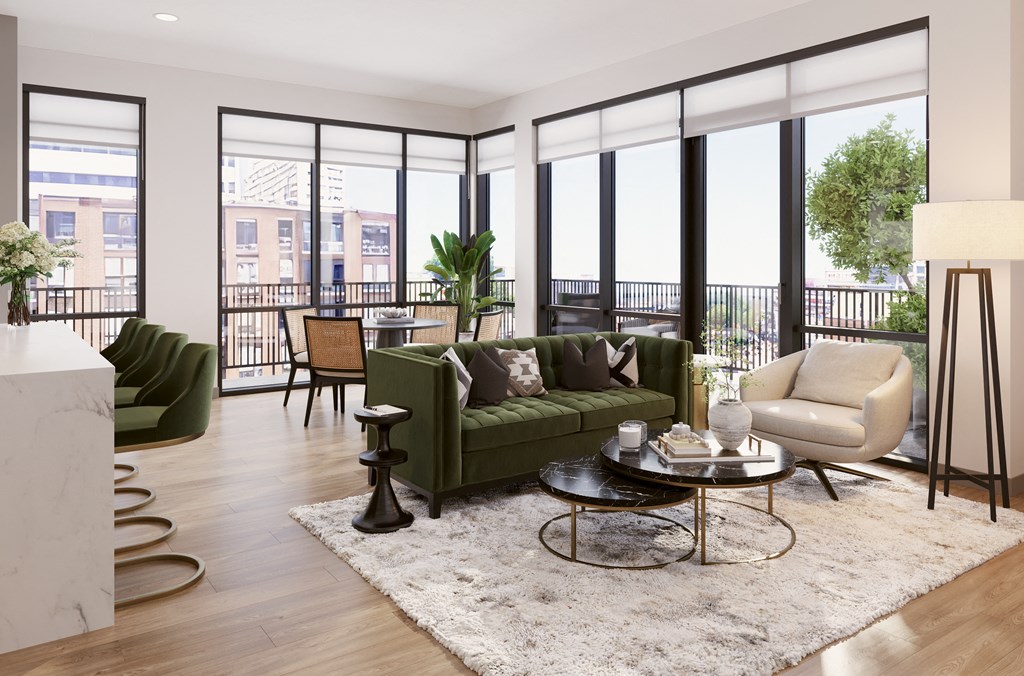 a living room with a green couch and chairs and a rug at Bemiston Place Apartments, Clayton, MO 63105