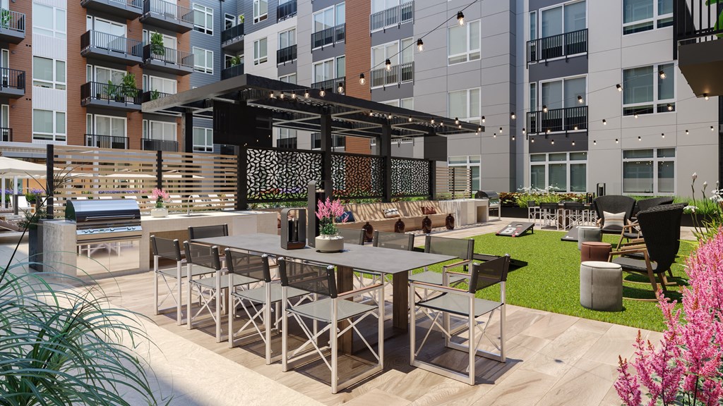 a rendering of an outdoor patio area with tables and chairs at Bemiston Place Apartments, Clayton, MO