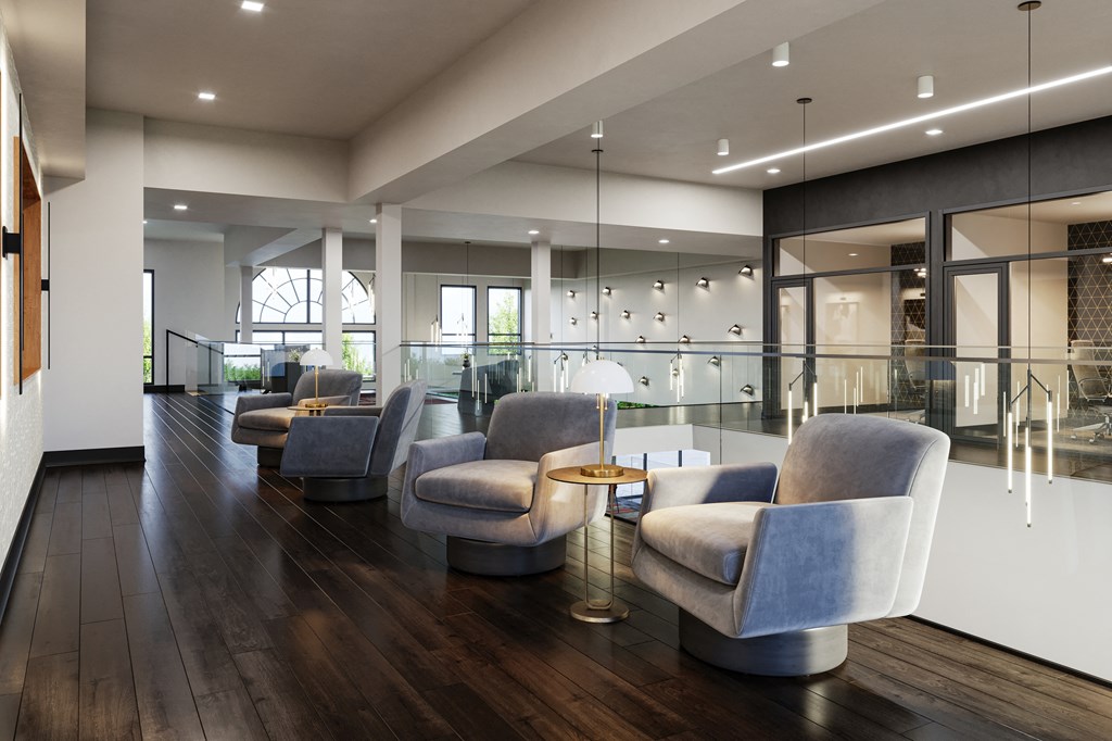 a lounge area with couches and chairs on a wooden floor