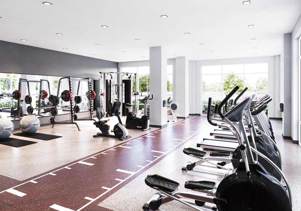 a gym with treadmills and other exercise equipment in a large room