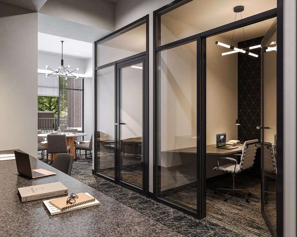 a conference room with glass walls and a table with a laptop