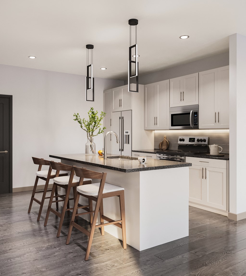 a kitchen with white cabinets and a island with bar stools