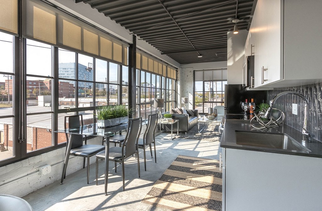 a kitchen and dining area with large windows and a city view