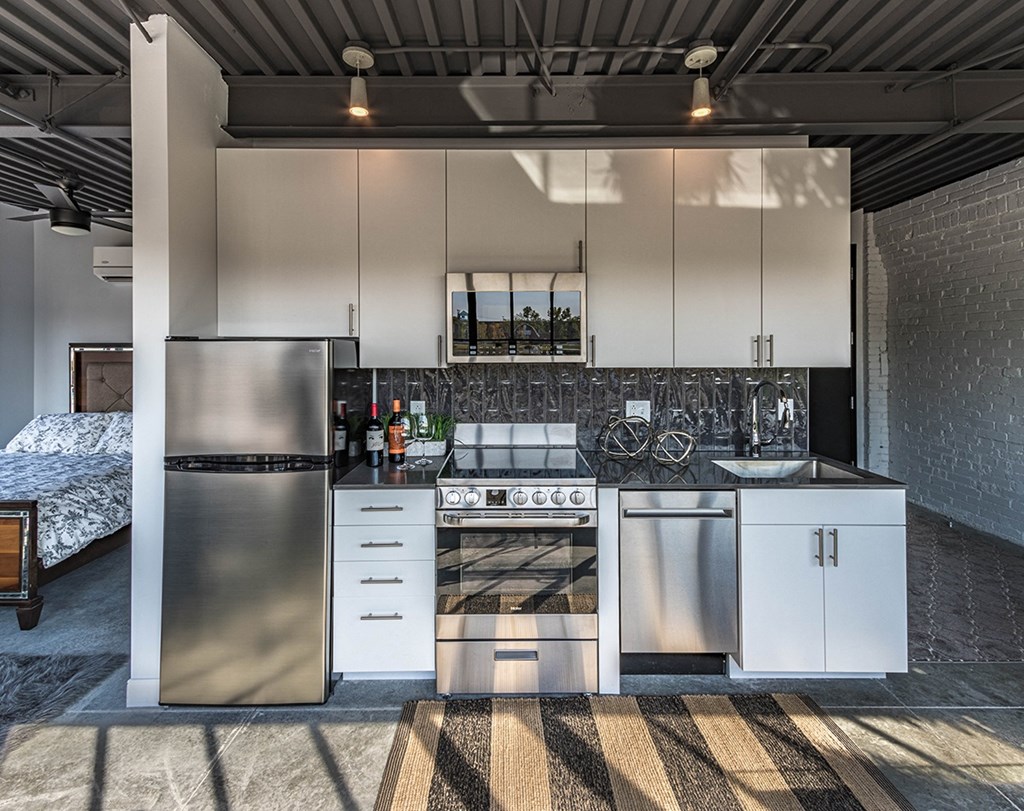 a kitchen with white cabinets and stainless steel appliances