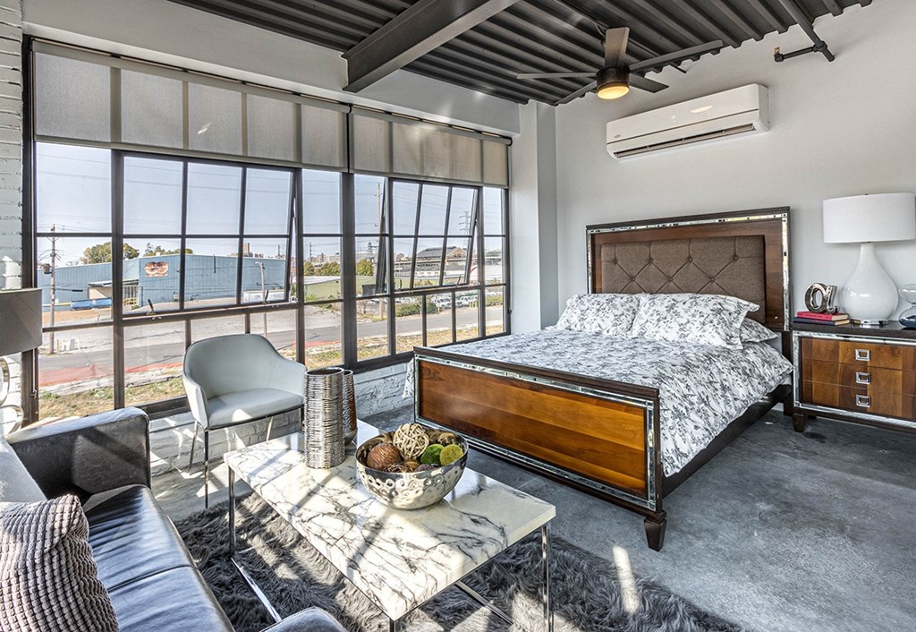 a bedroom with a bed and a view of the water