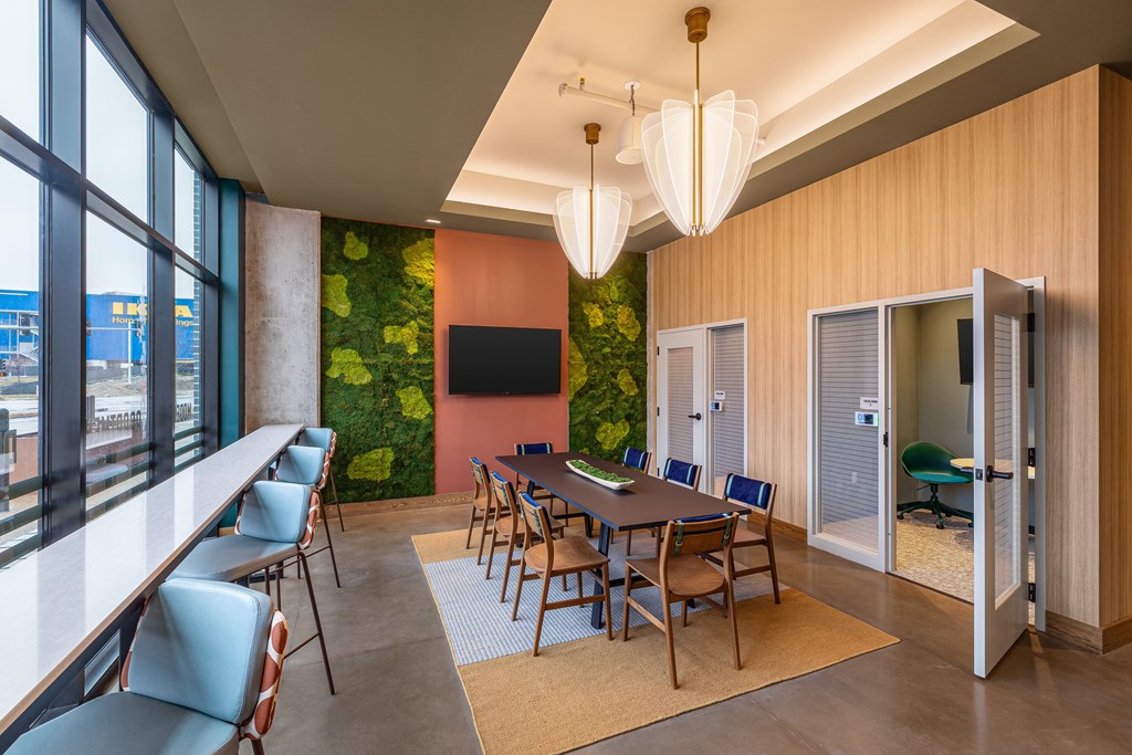 A conference room with a long table and chairs.