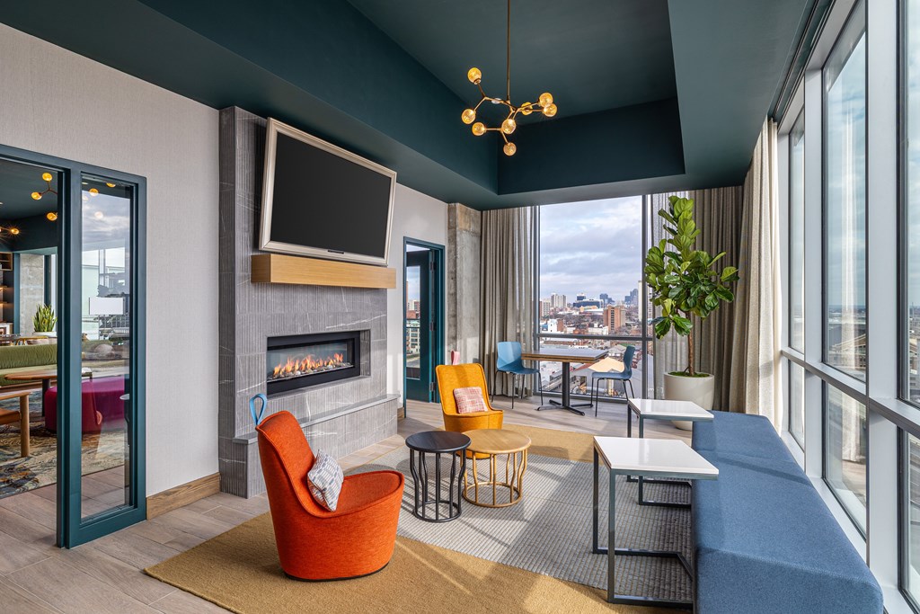 A modern living room with a fireplace and a flat screen TV.