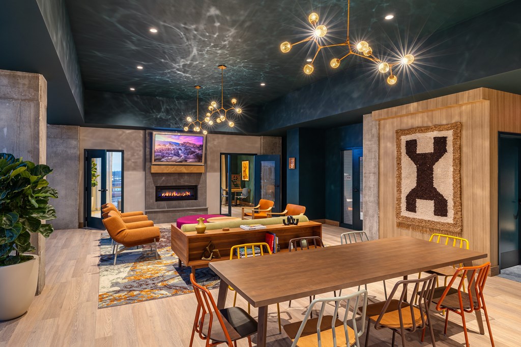 A modern dining room with a wooden table and chairs.