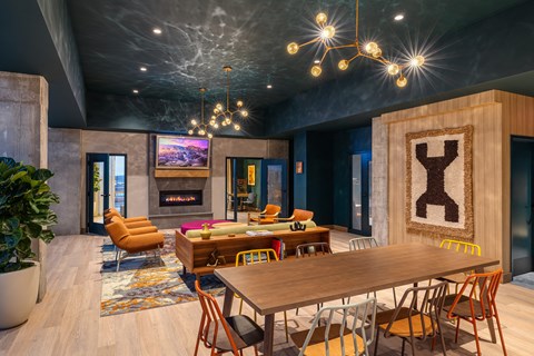 A modern dining room with a wooden table and chairs.