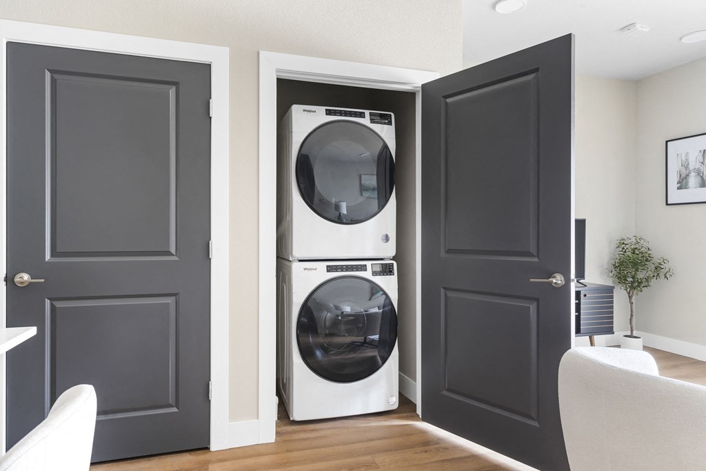 a white washer and dryer in a room with black doors at The Junction at Rogers, Rogers