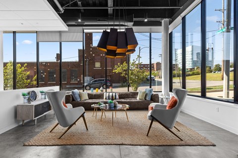 A modern living room with a large window and a view of the city.
