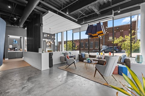 A modern office space with a reception desk and comfortable seating areas.