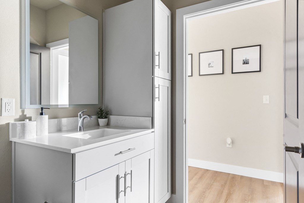 a bathroom with a sink and a mirror at The Junction at Rogers, Rogers