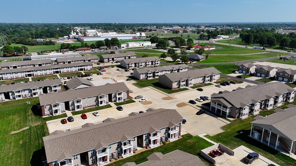 A large housing complex with multiple homes and driveways.