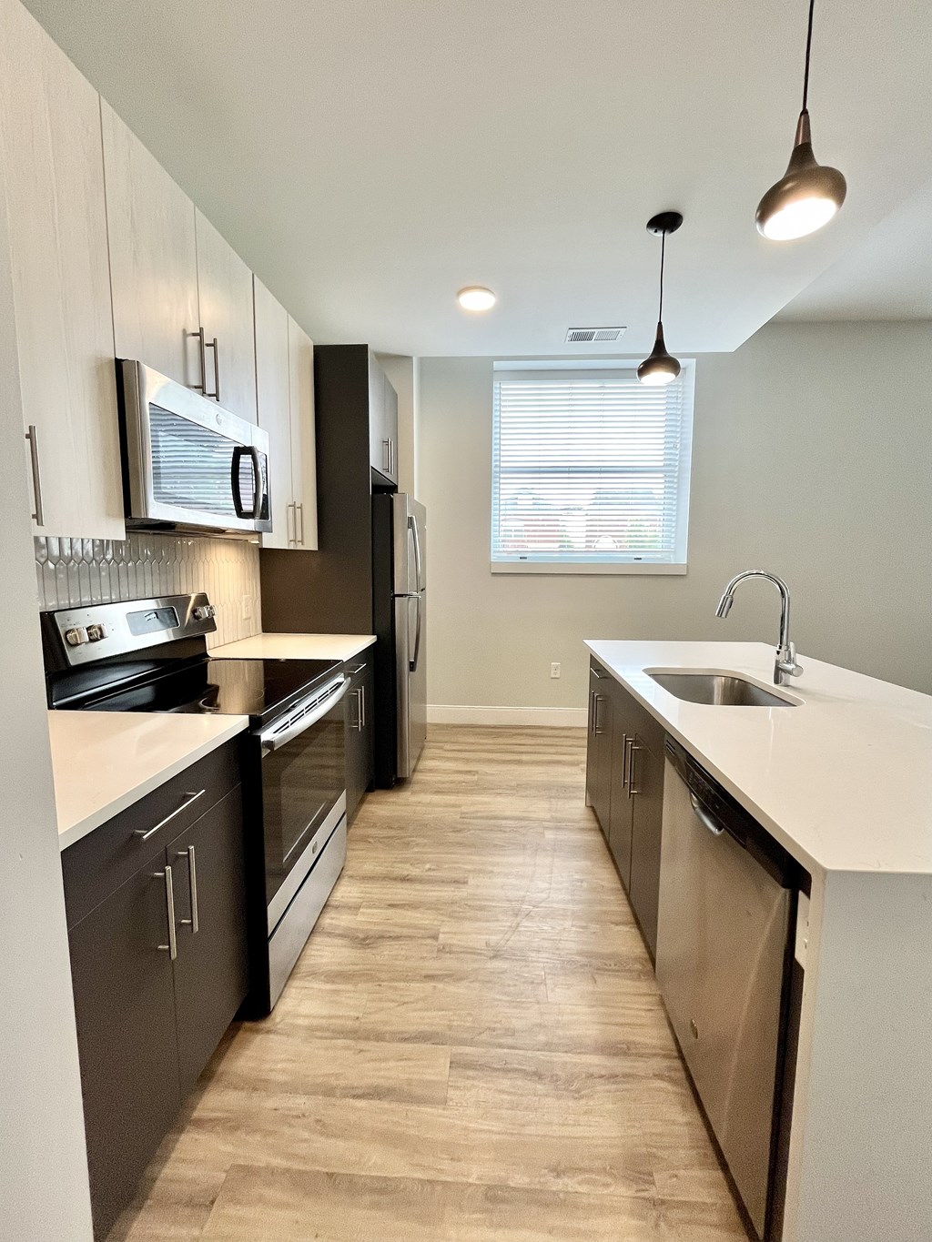 A kitchen with dark wood cabinets and stainless steel appliances.